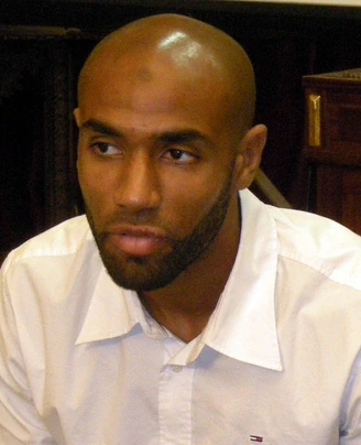 Frédéric Kanouté seated indoors in a white shirt