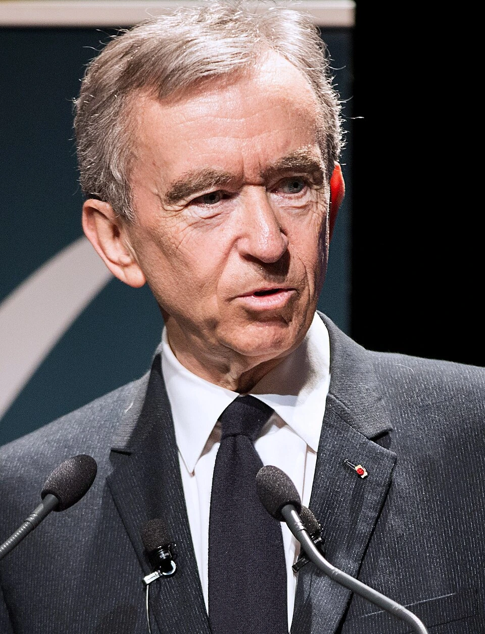 Bernard Arnault speaking at a podium
