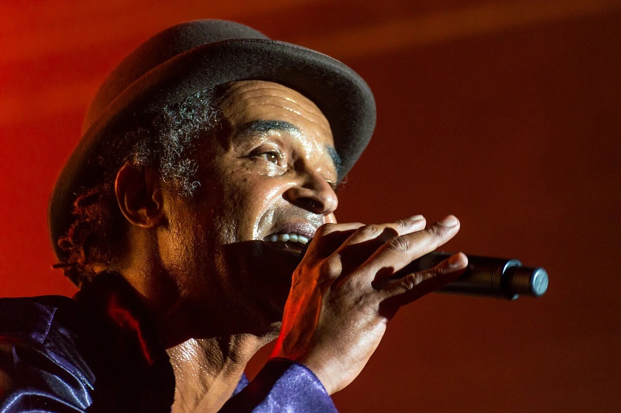 Yannick Noah performing on stage, singing into a microphone