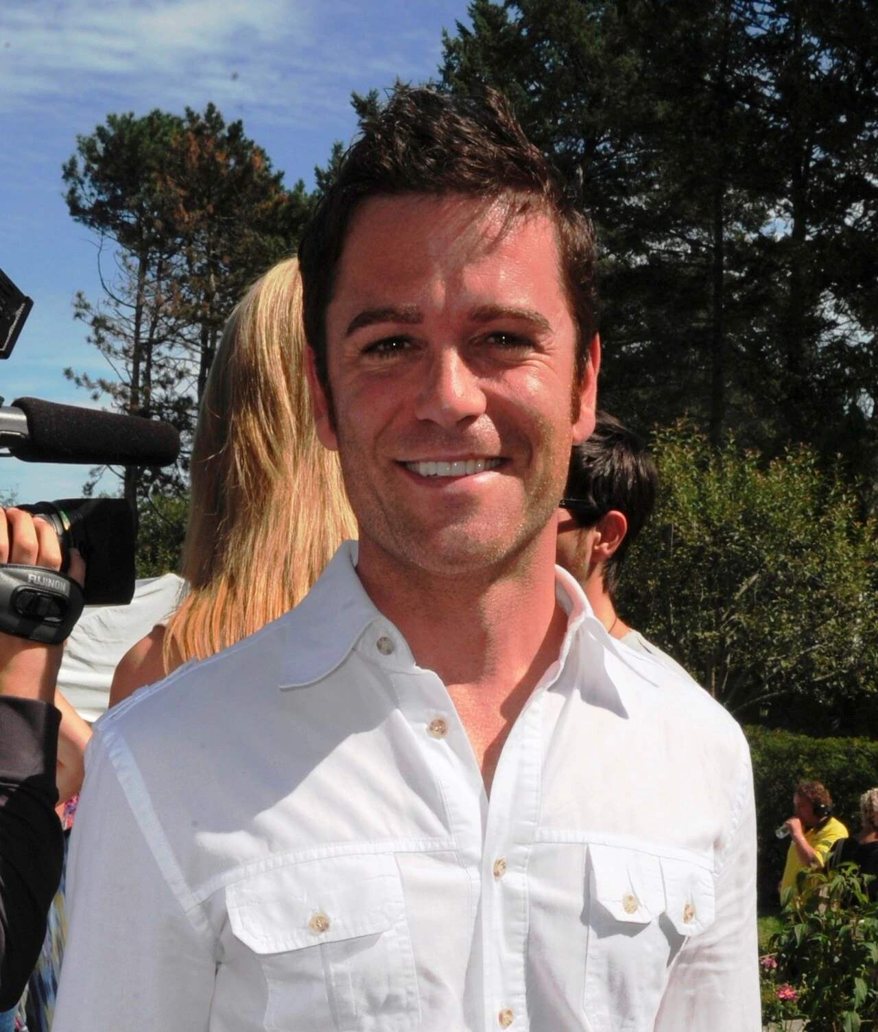 Yannick Bisson at the Canadian Film Centre Annual BBQ, smiling outdoors in a white shirt